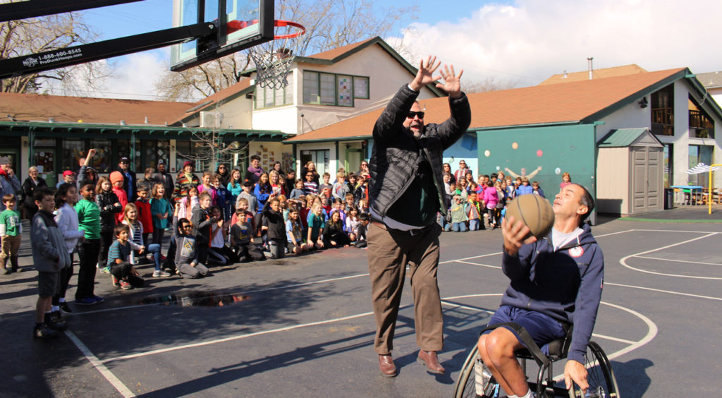 Carlstroem in basketball game with person using wheelchair